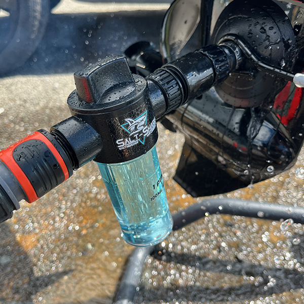 A full Engine Flush Adaptor attached to an outboard engine with Salt-Shark salt removal product being flushed through engine  - Smack Marine & RV