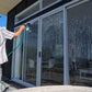 Salt-Shark being sprayed of a beach house removing salt off the windows.  smackmarine.com